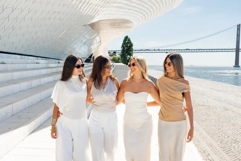 Rupali, Coral and the Details Weddings team walking by the river in Lisbon